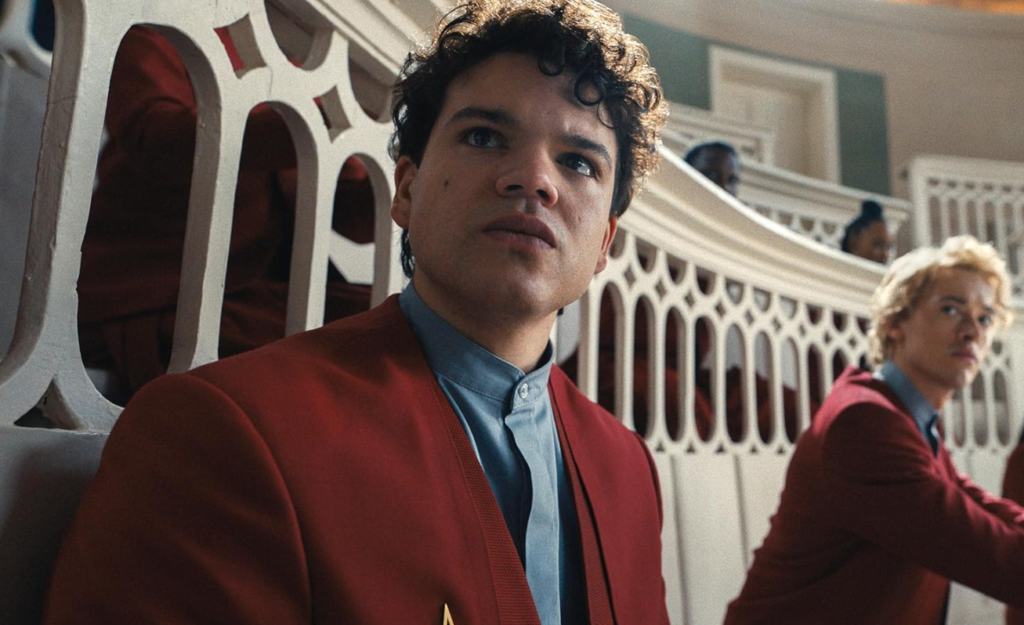 Sejanus Plinth debating the morality of the Hunger Games while Coriolanus Snow watches in the background.