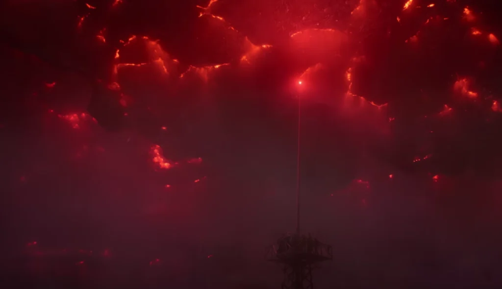 Red lightning from the Upside Down striking the radio tower in Hawkins during the Stranger Things Season 5 finale.