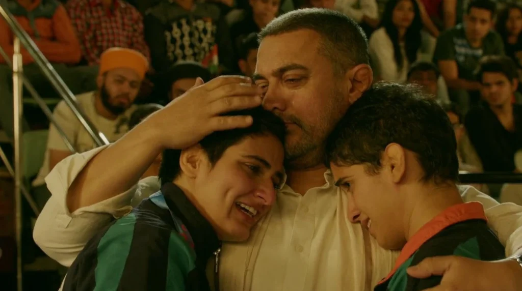 A proud Mahavir hugging his daughters Geeta and Babita, proving why my Dangal rewatch score is so high.