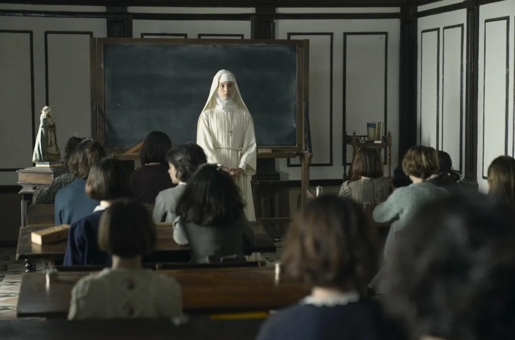 Narcisa looking at the young girls sitting in the classroom in Sister Death movie review.
